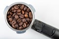 Black roasted coffee beans and a coffee machine flask. Coffee making accessories Royalty Free Stock Photo