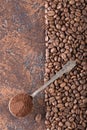 Black roasted coffee grains and ground coffee in spoon lie on a