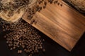 Black roasted coffee grains. On a wood background. Top view and frame for inscriptions.