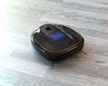 Black robotic vacuum cleaner on laminate flooring