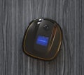 Black robotic vacuum cleaner on laminate flooring