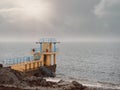 Black rock diving tower, Salthill beach, Galway bay, Dramatic stormy sky over the ocean`s water Royalty Free Stock Photo