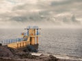 Black rock diving tower, Salthill beach, Galway bay, Dramatic stormy sky over the ocean`s water Royalty Free Stock Photo