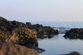 Black rock that is inundated with water from the sea