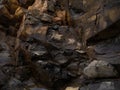 Black rock, stone, textured. Background for design. Hard light Royalty Free Stock Photo