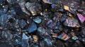 Black rocky surface with iridescent reflections.