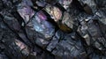 Black rocky surface with iridescent reflections. Black titanium, tourmaline, hematite sample.