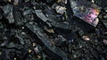 Black rocky surface with iridescent reflections. Black titanium, tourmaline, hematite sample.