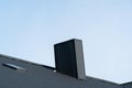 Black roofing of metal profile wavy shape. Roof with a skylight and a chimney Royalty Free Stock Photo