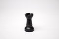 Black rook chess piece on a white background