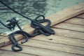 Black rope on bridge as part of yacht anchor. Detail of sailboat Royalty Free Stock Photo