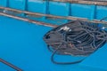 Black rope coiled up in bottom of boat Royalty Free Stock Photo