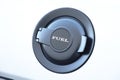 Black round fuel cap on white car close up Royalty Free Stock Photo