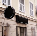 Black, round logo sign on the wall