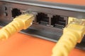 Black router in which yellow patch cords are inserted