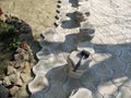 Black rubber hammer lies on a pile of paving slabs during its laying, background with copy space, top view. The concept of Royalty Free Stock Photo