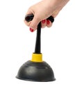 Black rubber plunger in a female hand on a white isolated background Royalty Free Stock Photo