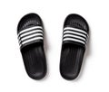 Black rubber slippers isolated on white. Pair of slide sandals closeup. Light shoes for pool or shower. Comfortable beach flip Royalty Free Stock Photo