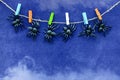 Black rubber spider toys hang on colorful clothespins on blue velvet paper background with smoke. Halloween october concept. Royalty Free Stock Photo