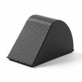 A black rubber wheel chock with a triangular prism shape. Its surface is textured for Royalty Free Stock Photo