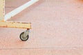 Black rubber wheel rusty old small metal transportation metal on floor sandstone Royalty Free Stock Photo