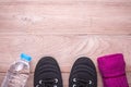 Black Running / Sneaker shoe, water bottle and towel on brown wo Royalty Free Stock Photo