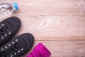 Black Running / Sneaker shoe, water bottle and towel on brown wo Royalty Free Stock Photo