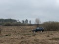 Black Russian off-road car Lada Niva 4x4 VAZ 2121 / 21214 parked on the field.