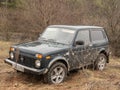 Black Russian off-road car Lada Niva 4x4 VAZ 2121 / 21214 parked on the field.