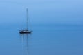 Sailing boat alone in the ocean during blue twilight hour Royalty Free Stock Photo