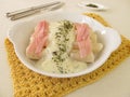 Black salsify roots with bechamel sauce and cooked ham