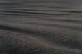 Black sand beach macro photography. Silky black beach texture with shallow depth of field. Minimalistic black background Royalty Free Stock Photo