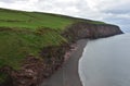 Black Sand Beach with Red Rock Sea Cliffs in England