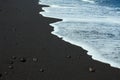 Black sand beach with white ocean foam Royalty Free Stock Photo