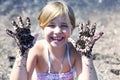 Black sand on children`s hands Royalty Free Stock Photo