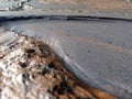 Black sand and coral that became one drifted away by the river current