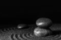 Black sand with stones and beautiful pattern against background. Zen concept Royalty Free Stock Photo