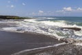 Black sand volcanic beach and white waves of ocean in Bali, Indonesia Royalty Free Stock Photo