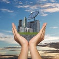 Black Satellite dish in hand of businessman and have Skyscraper Royalty Free Stock Photo