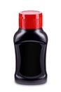 Black sauce bottle with red flip-top cap and black label isolated on white background. Royalty Free Stock Photo