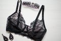 Black saxy lingerie on the white background with red rose and wo