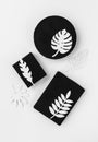 Black Scandinavian style gift set with white tropical paper leaves