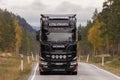Black Scania truck driving at road