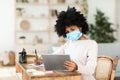 Black School Girl Learning Wearing Mask Using Digital Tablet Indoors Royalty Free Stock Photo