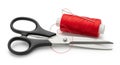 Black scissors and bright red thread spool with needle isolated on white background for sewing and crafting concepts Royalty Free Stock Photo