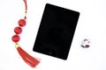 Black screen tablet and chinese new year decor on white background. Oriental festival present top view photo Royalty Free Stock Photo