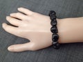 Black scull beads bracelet Lord Shiva worship on mannequin hand Royalty Free Stock Photo