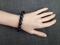 Black scull beads bracelet Lord Shiva worship on mannequin hand Royalty Free Stock Photo