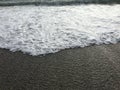 Black Sea coast, sunny day with a view of the blue sky horizon and sea foam waves. Pebbles - round sea stones. Sea stones, pebbles Royalty Free Stock Photo