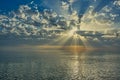 The Black Sea in the evening with the setting sun. Godrays come from the bright clouds illuminating the scene. Seaside landscapes